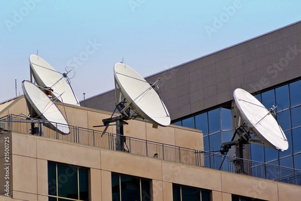 Obraz Four Satellite Dishes on Building Rooftop