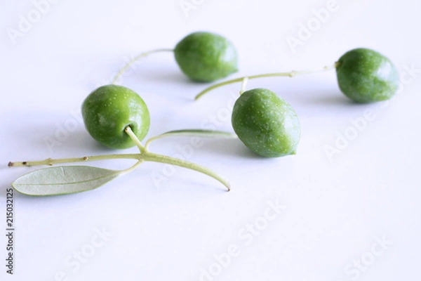 Fototapeta Fresh green olives isolated on white background close up.Blurred background.