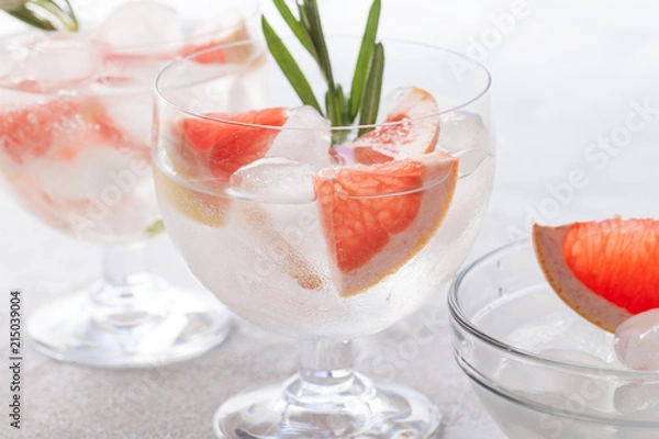 Fototapeta Citrus lemonade water with grapefruit sliced , healthy and detox water drink in summer on concrete table.