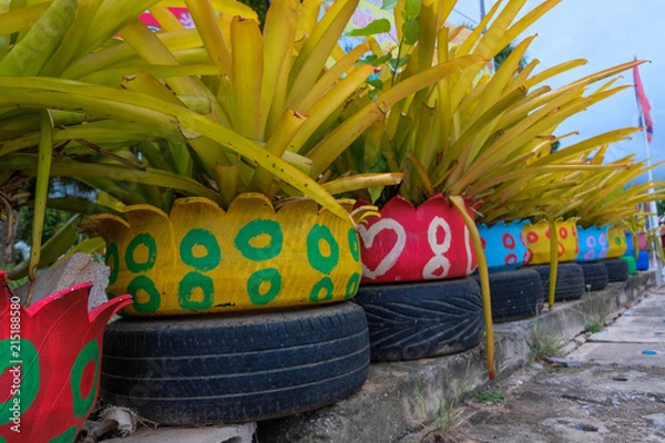 Obraz Colored green planters made from recycled tires.