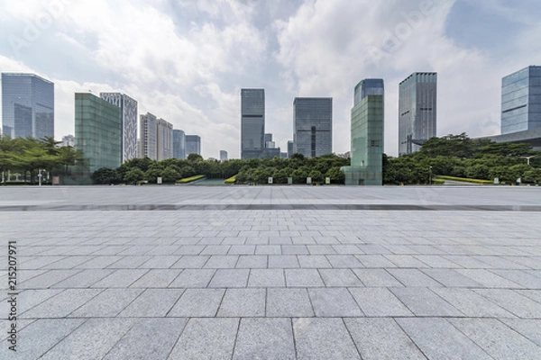 Fototapeta Panoramic skyline and modern business office buildings with empty road,empty concrete square floor