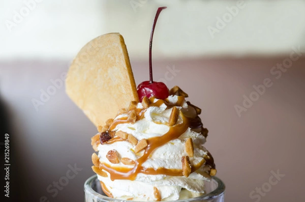 Fototapeta ice cream sundae with cherry and wafer topping