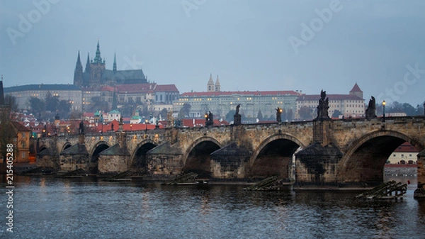 Fototapeta Charles bridge of Prague with foggy day and Prague castle in Czech Republic