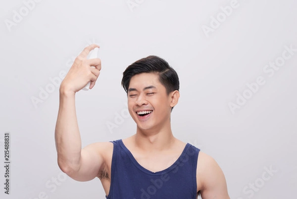 Fototapeta Handsome man with perfume close up portrait studio on white background