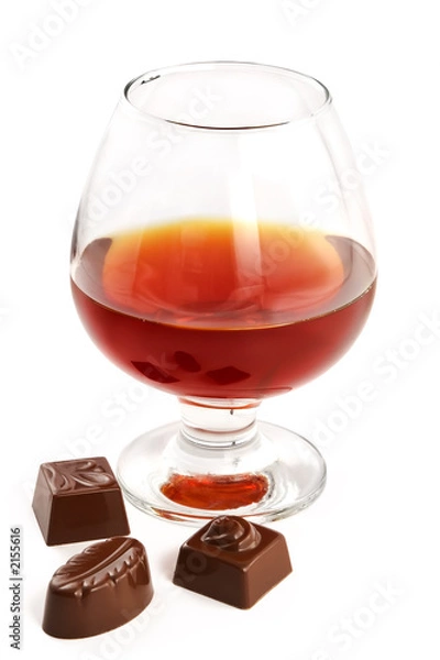 Obraz glass with cognac and sweets with liquor