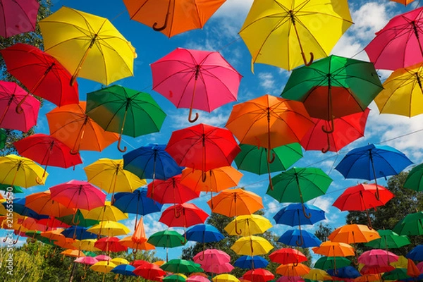 Fototapeta Lots of colorful umbrellas in the sky. City decoration