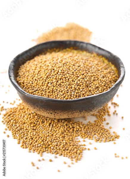 Fototapeta Heap of raw, unprocessed mustard seed kernels in bowl on white