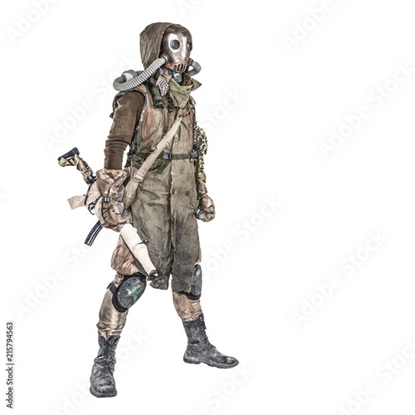 Fototapeta Survivor inhabitant of contaminated by nuclear catastrophe or dangerous chemical pollution world, in tatters and gas mask, standing with handmade firearm gun, isolated on white background studio shoot