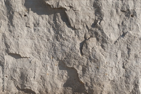 Fototapeta Background geology closeup limestone rock face showing weathered strata wallpaper