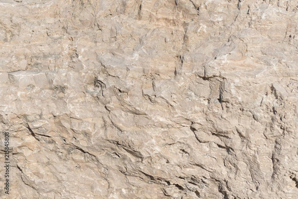 Fototapeta Background geology closeup limestone rock face showing weathered strata wallpaper