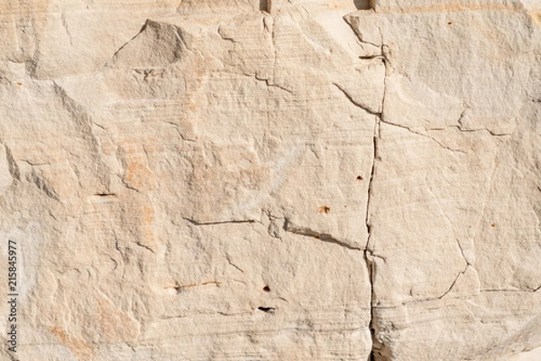 Fototapeta Background geology closeup limestone rock face showing weathered strata wallpaper