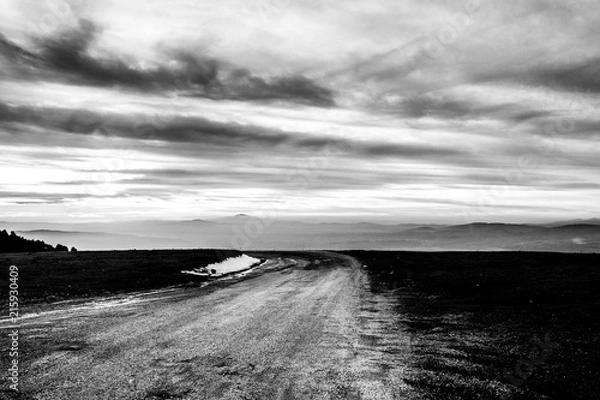 Fototapeta Subasio Mt. (Umbria, Italy), with sky covered by clouds and mist on the valley underneath