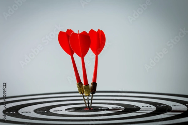 Obraz dart arrow hitting in the target center of dartboard. concept of the success