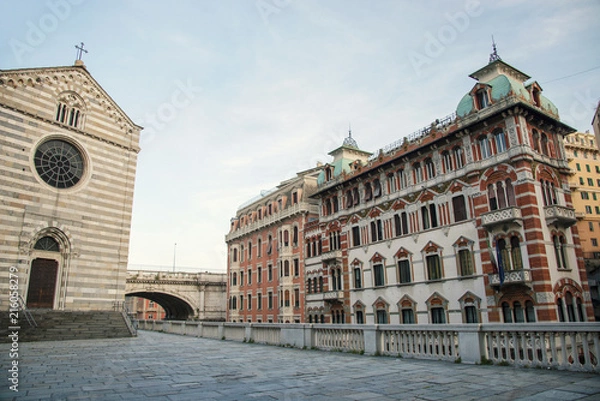 Fototapeta View over cathedral Santo Stefano and traditional style buildings at sunset time at Genoa, Italy
