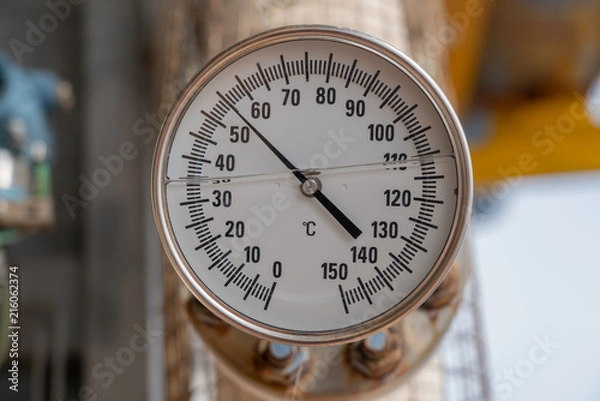 Fototapeta Analog temperature gauge for reading discharge temp of compressor at offshore oil and gas wellhead remote platform.