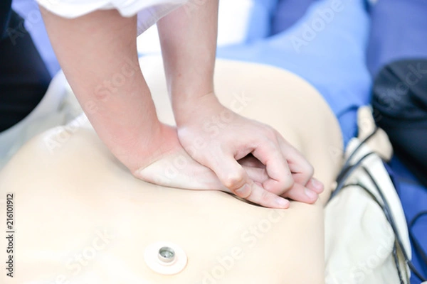 Fototapeta Basic Life Support of Demonstrating chest compressions on CPR doll
