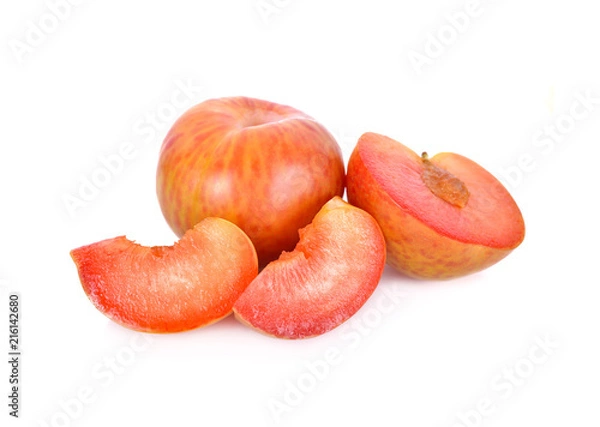 Obraz whole and sliced fresh pluot on white background