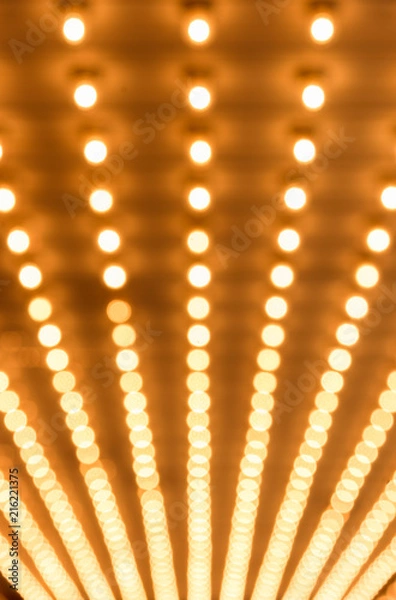 Fototapeta Rows of illuminated globes under the marquee as often used at entrance to theatres and casinos
