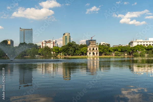 Fototapeta Hoan Kiem lake or Sword lake, Ho Guom in Hanoi, Vietnam with Turtle Tower, on clear day with blue sky and white clouds