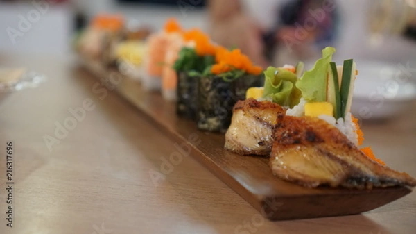 Fototapeta Close-up to selective at the front of japanese sushi rolls dish.
