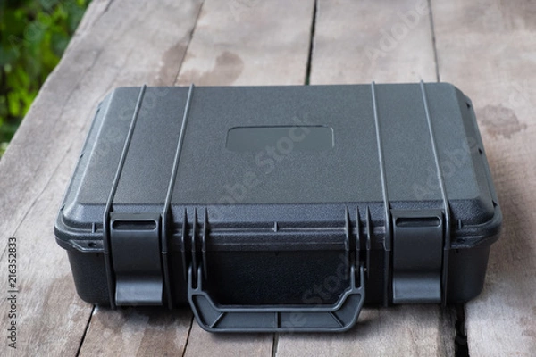 Fototapeta safety black case on wood