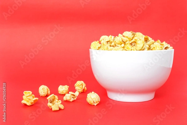 Obraz popcorn white bowl on red background