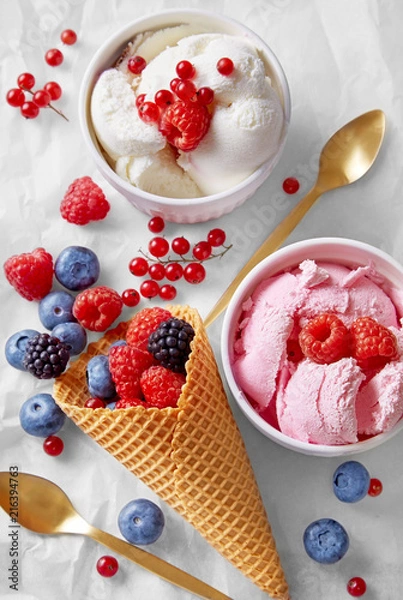 Fototapeta Ice cream cone with assortment of fruits and ice cream flavours viewed from above. Homemade raspberry and vanilla ice cream in a cups. Top view