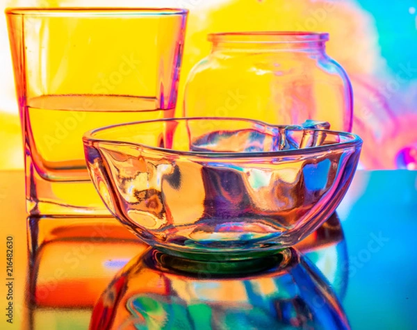 Fototapeta Glass of water with drop and colored background