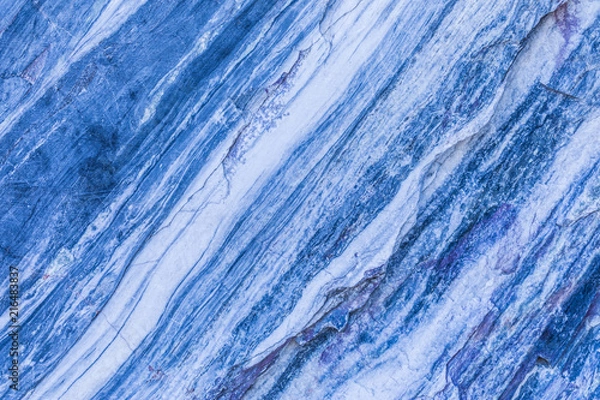 Fototapeta The background or texture of the marble wall of the quarry or opencast. The surface of the marble stone or rock
