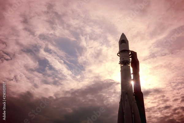 Obraz A rocket on the launch pad against the background of the dawn sky.