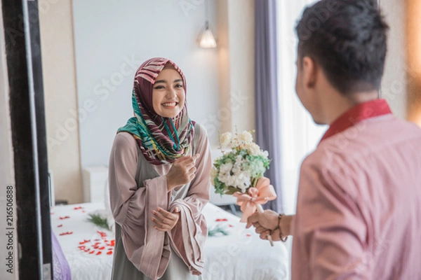 Fototapeta muslim woman receiving flower from her husband