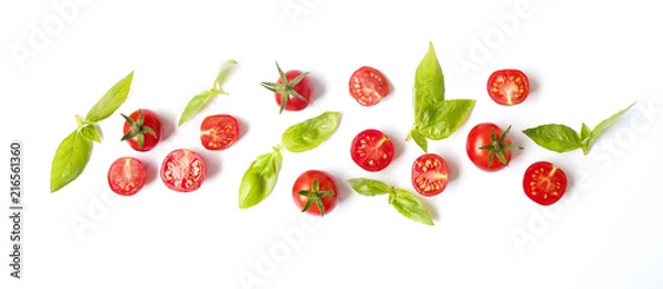 Obraz Bunch of beautiful juicy organic red cherry tomatoes, green basil leaves on white background. Shiny polished glossy vegetables. Clean eating concept. Vegetarian diet. Copy space, flat lay, top view.