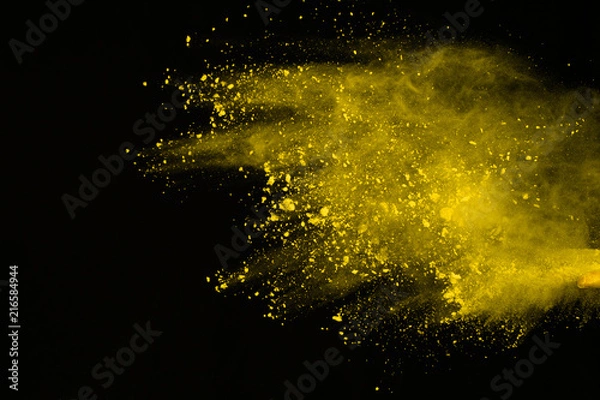 Fototapeta Explosion of colored powder isolated on white background. Power or clouds splatted. Freez motion of yellow dust exploding.
