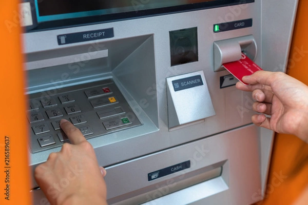 Obraz Closeup woman withdrawing the cash via ATM, business Automatic Teller Machine concept