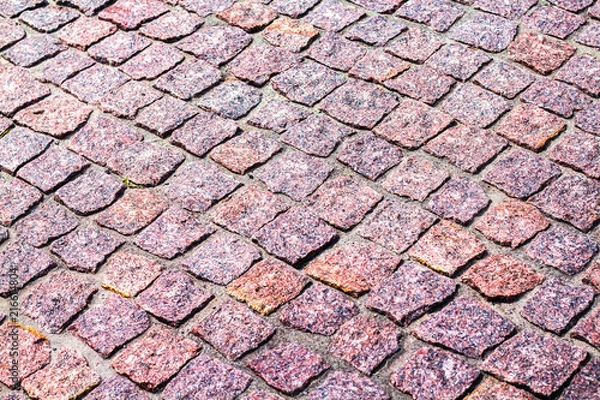 Fototapeta fragment of granite pavers at an angle in different color schemes