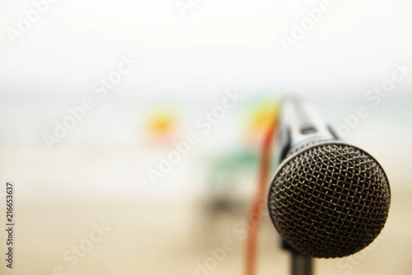Obraz close up microphone on blurred beach background