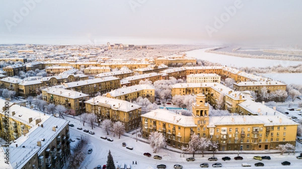 Fototapeta Drone photo of Magnitogorsk city in the winter evening, building of the fifties, Russia