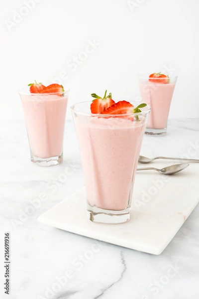 Fototapeta Three Glasses filled with Strawberry Mousse on Marble Board