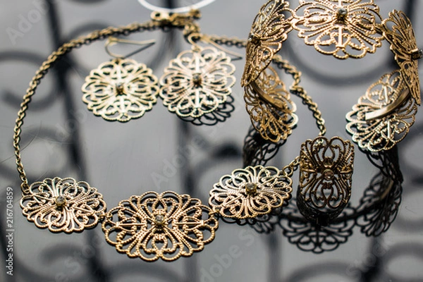 Obraz Gold jewelry is yellow and different shades. Jewelry from metal alloy with openwork patterns on the reflective surface. Stylish and fashionable design.