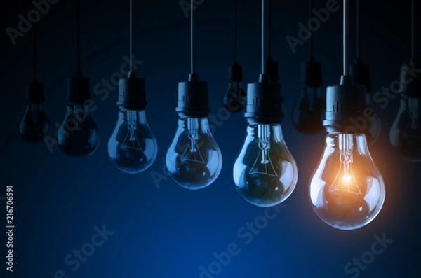 Fototapeta Lightbulbs on blue background, idea concept