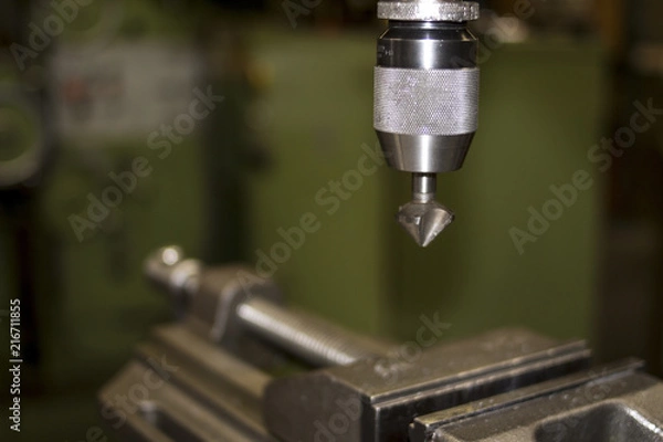 Obraz Industrial workshop with classic green drill machine for metal craft work with exchangeable countersink drill bit