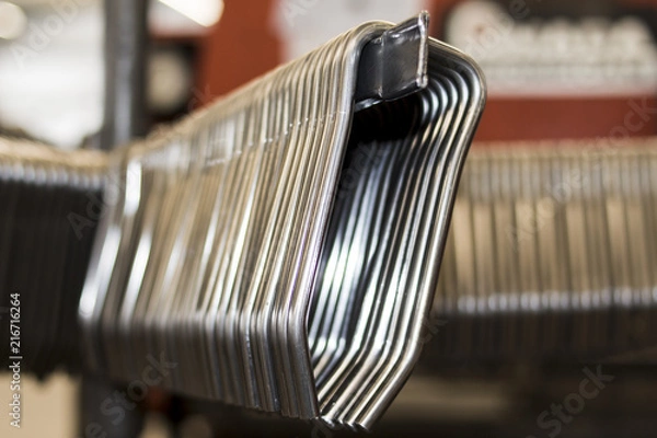 Obraz Stack of steel wire metal frames for producing shelves and other devices in a modern factory production line