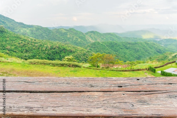Fototapeta Empty wood table and blur green mountain background