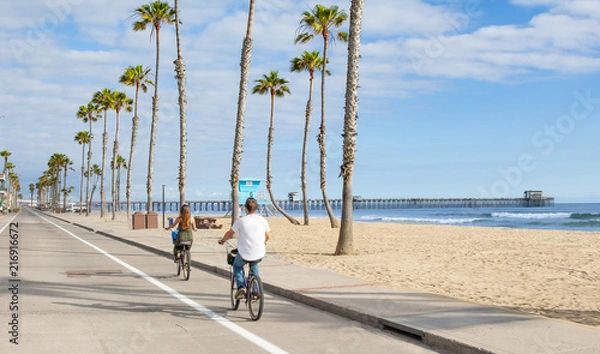 Obraz People riding Bikes at beach