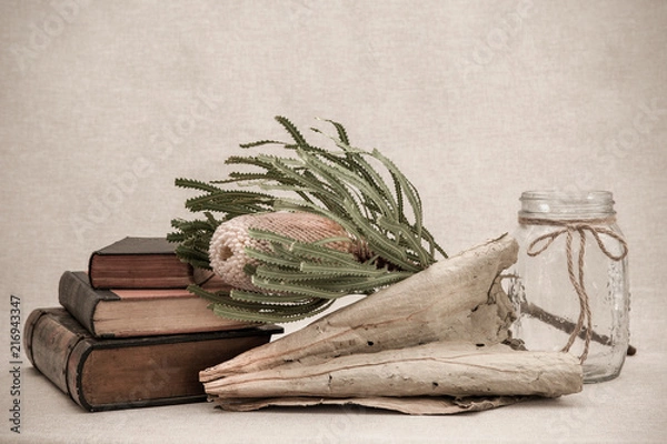 Obraz Lovely soft muted tones complement antique books, Australian wildflower and dried tobacco leaf.