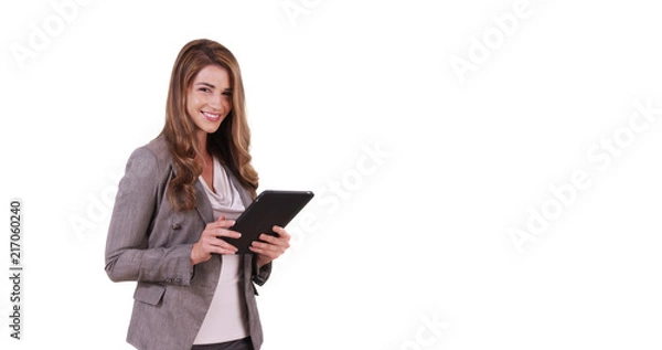 Fototapeta Portrait of good-looking white female using tablet device on white background