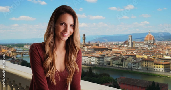 Fototapeta Smiling woman in Florence relaxing outside with view of cityscape