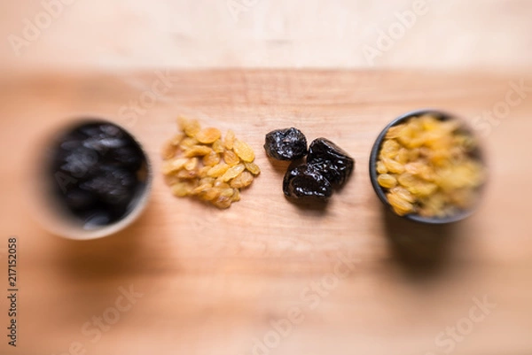 Obraz Prunes and raisins on wood board