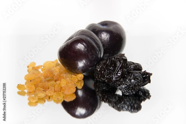 Fototapeta Raisins, plums and prunes on white background with reflection