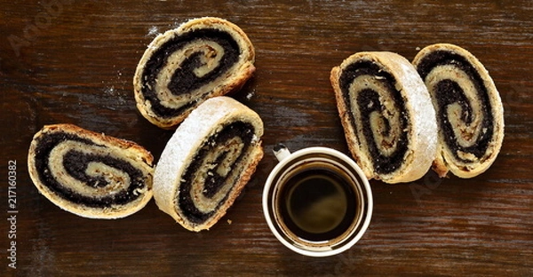 Fototapeta Poppy seed roll slices sprinkled with powdered sugar, top view